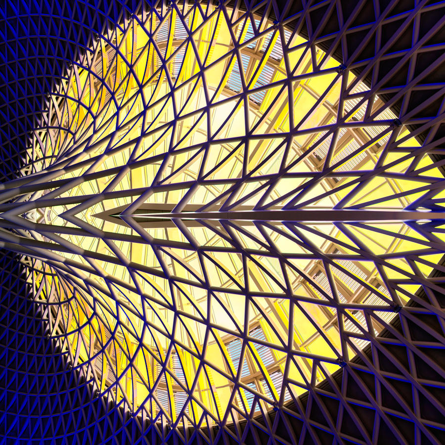 Geometric architectural roof lattice with yellow backlighting and repeating triangular pattern