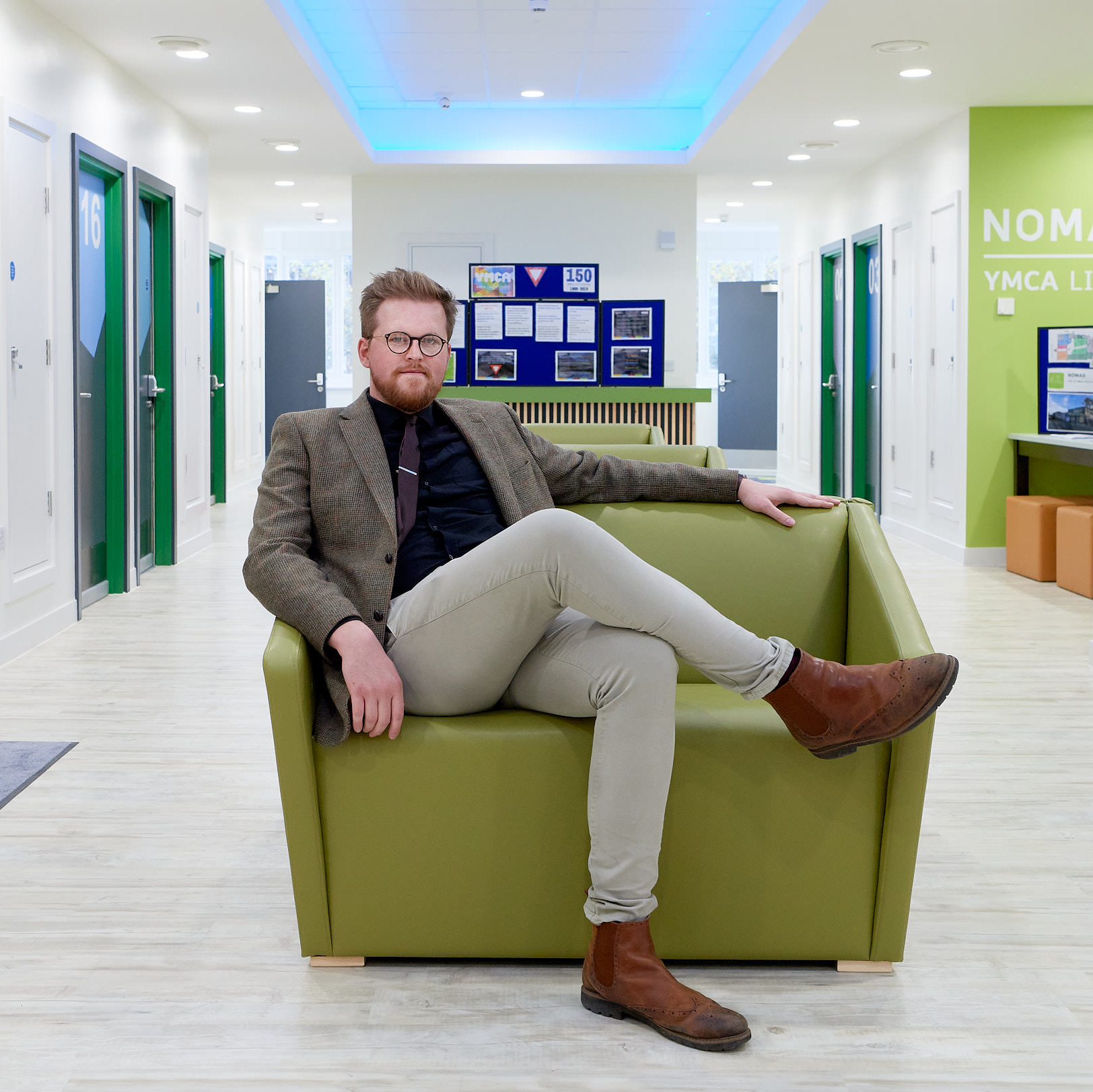 Corporate team image, colleague seated in office lounge