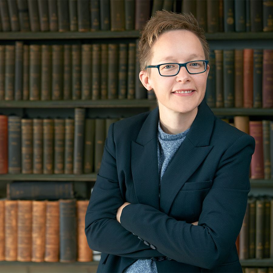 Corporate team image, executive portrait in front of bookshelves