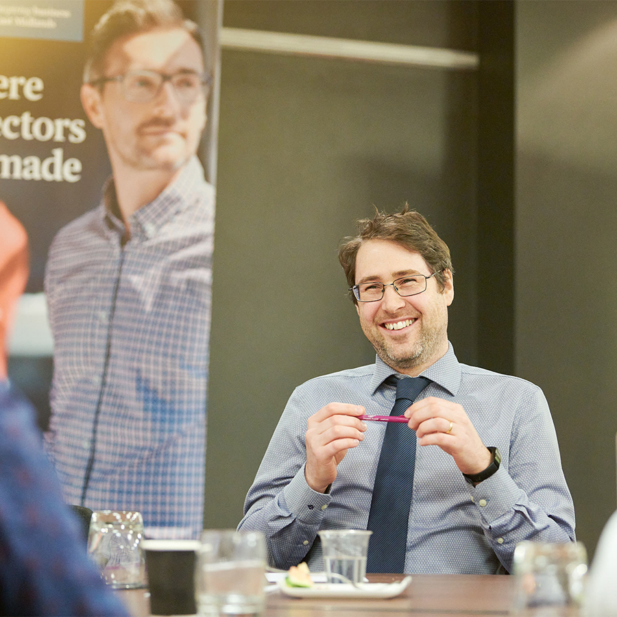Corporate team image, colleagues in discussion during meeting